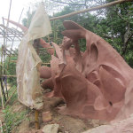 During the rainy season, plastic covers protect the works of art under restoration
